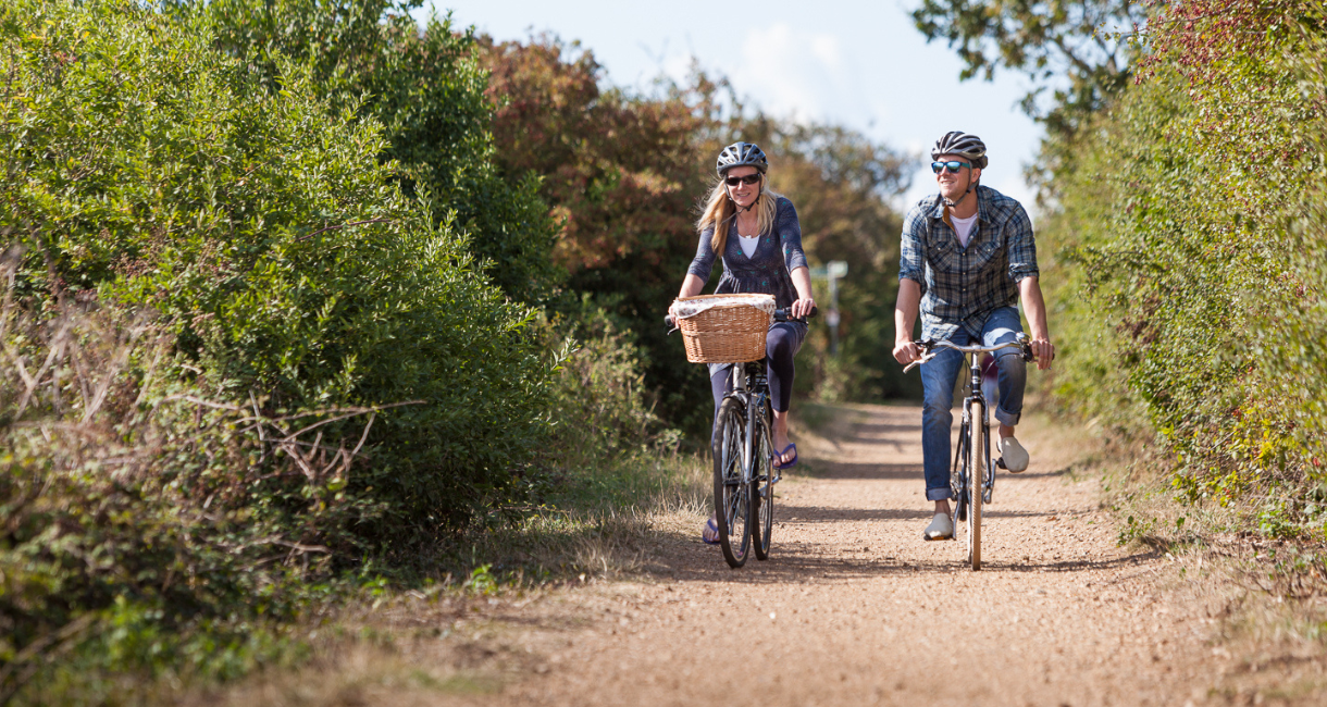 Couple cycling within the countryside on the Isle of Wight